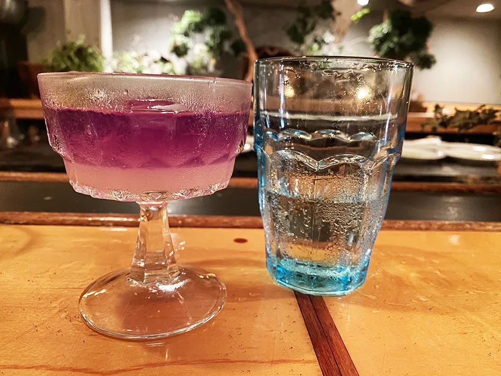 Hand-crafted cocktail at the CERALDi bar — lavender and blue glassware